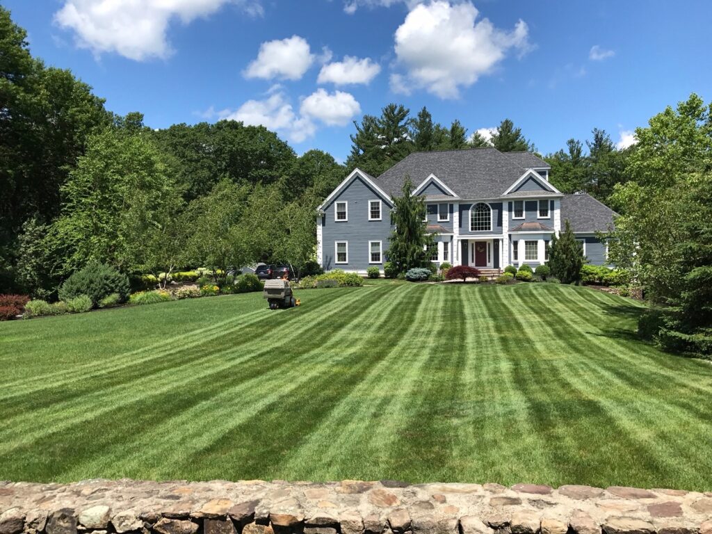 A large house with a large lawn in front of it.