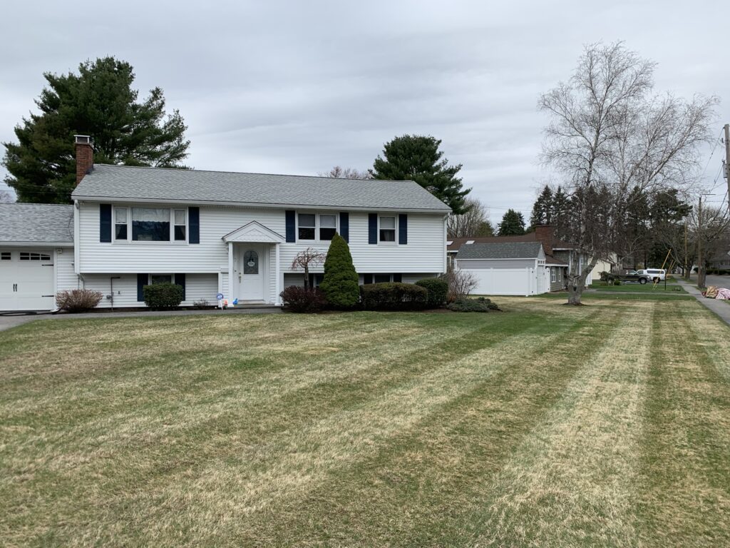 A house with a lawn in front of it.
