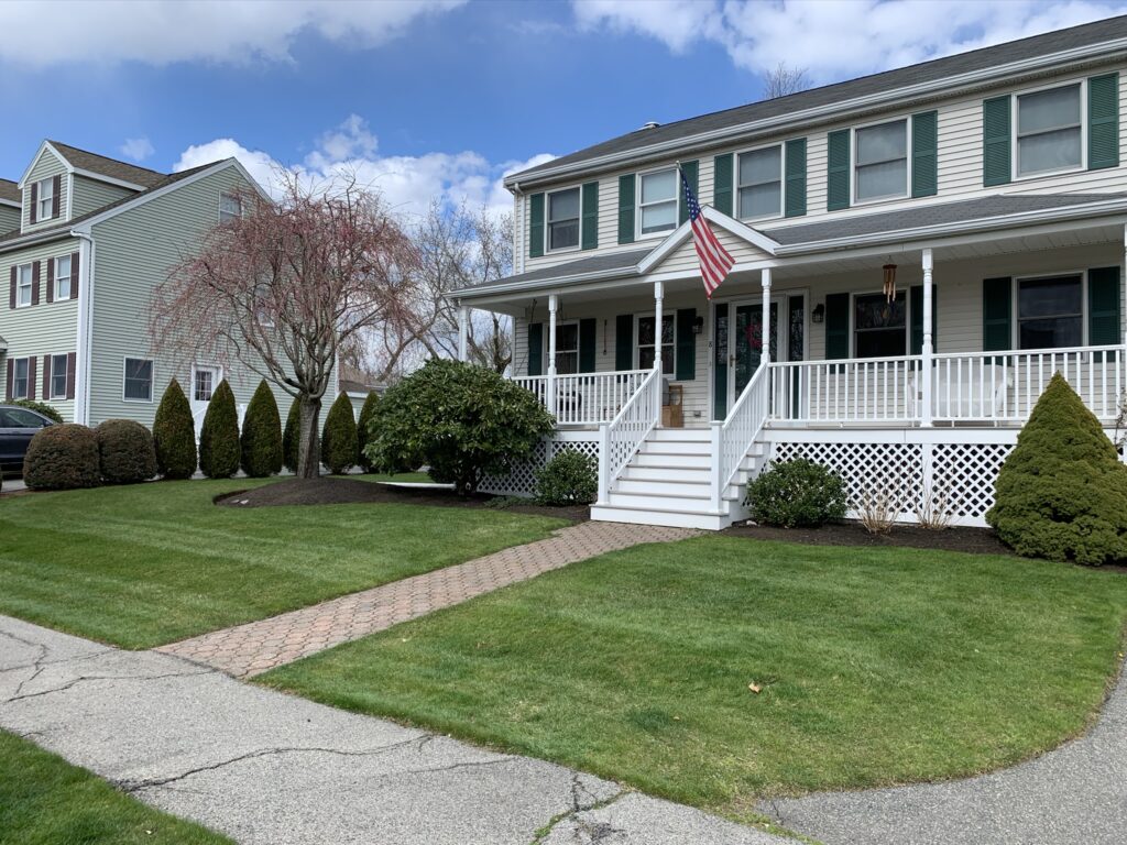 A house with a front porch and a lawn.