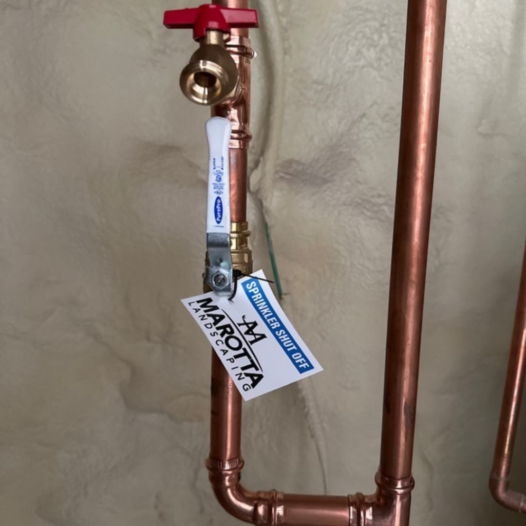 A copper pipe with a tag attached to it.