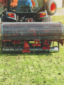 A tractor is mowing the grass.