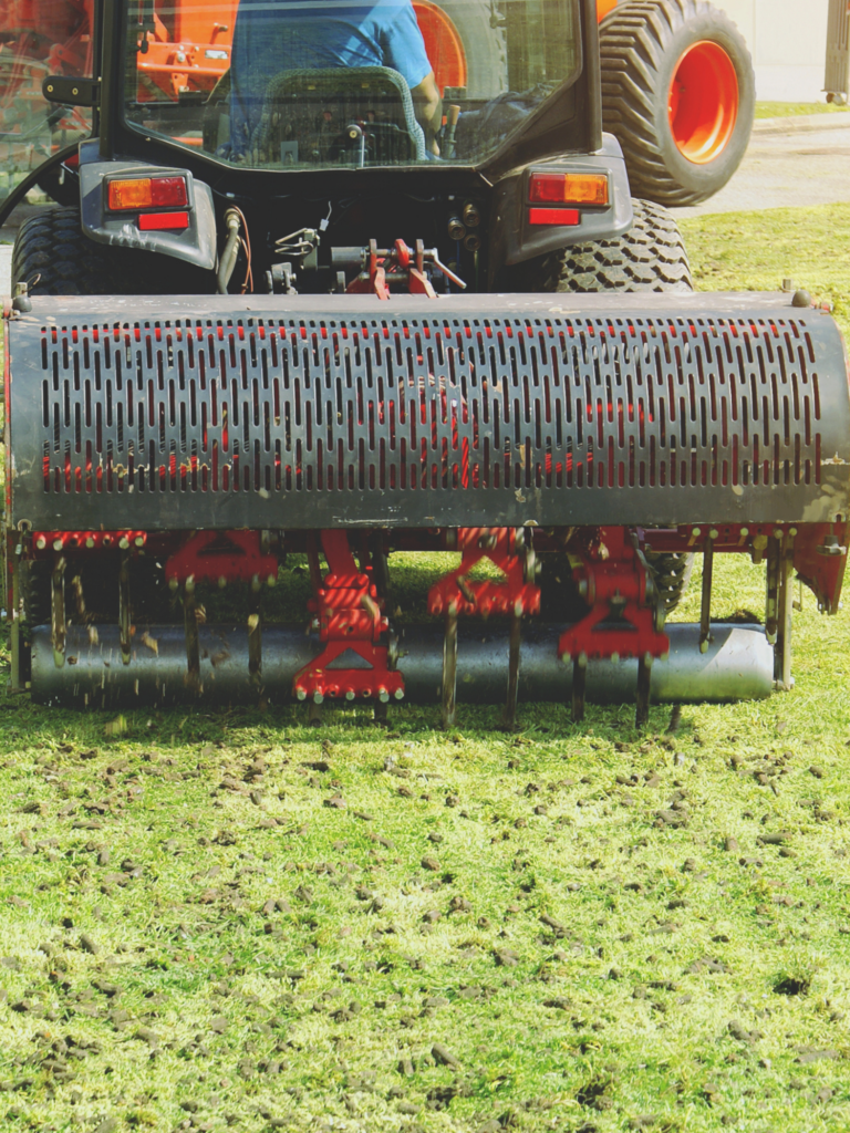 A tractor is mowing the grass.