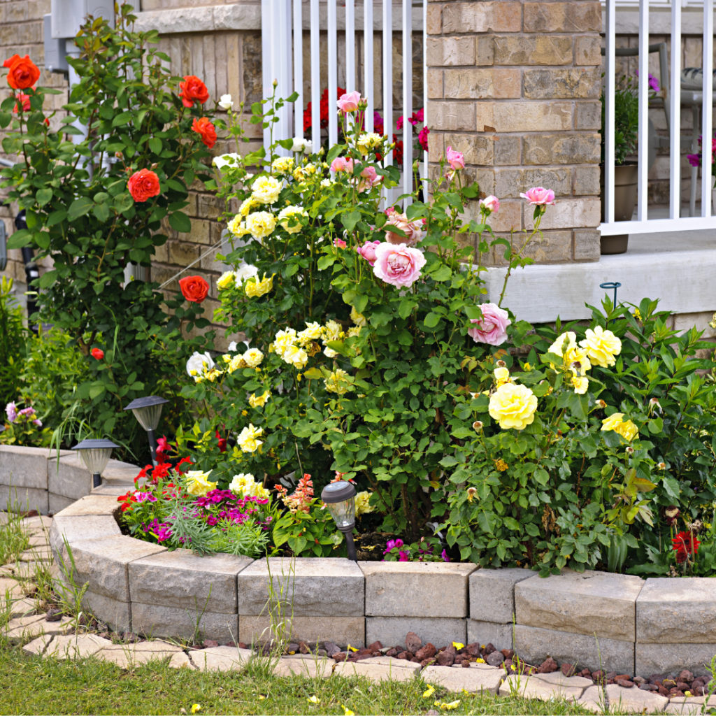 A flower bed in front of a house.